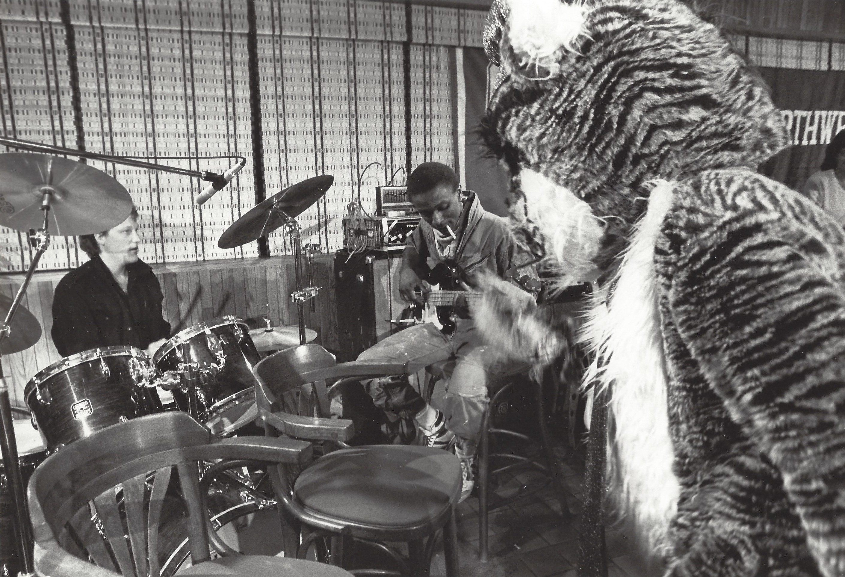 Ed, Kevin, and Willie the Wildcat share a moment between takes.