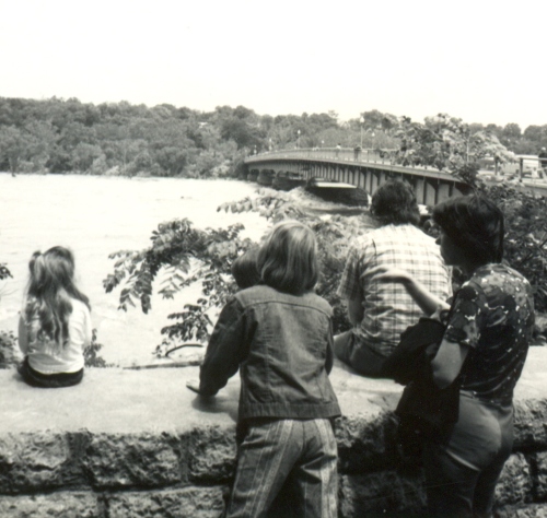 Strejceks watch the Potomac under Chain Bridge after Agnes flooding